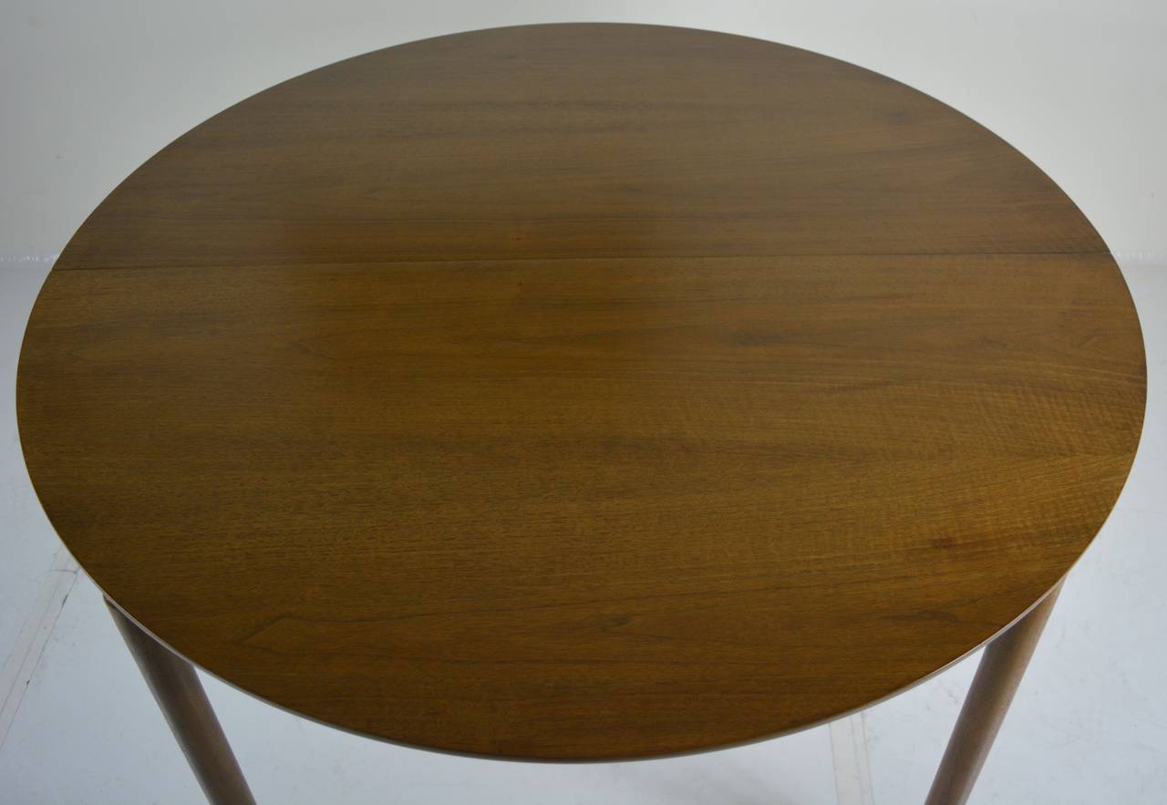 Round dining table in walnut by Greta Grossman for Glenn of California. This table has two 11.5