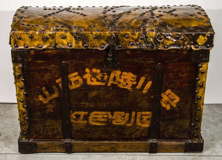 A beautifully weathered leather, elm and cast iron dancer's clothing trunk. With attractive Chinese calligraphy and original heavy cast iron handles.
From Xian, circa 1900.
CST321.
 
