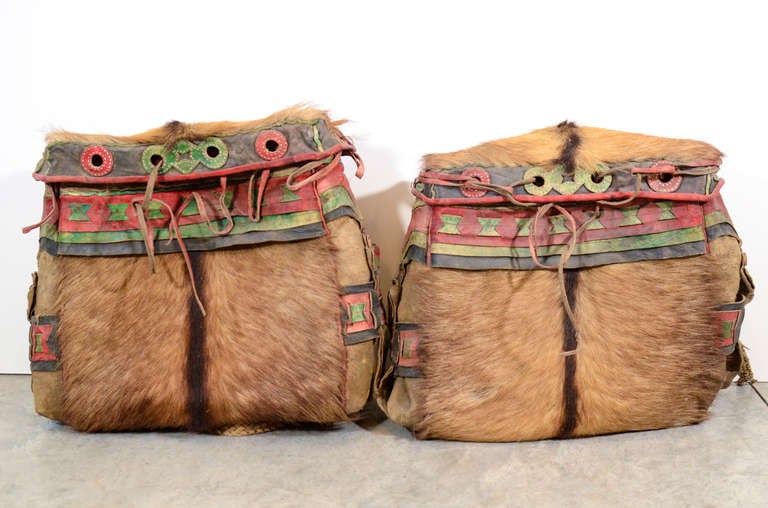 An unusual pair of antique Tibetan handmade saddle bags, with decorative colored leather and yak fur. Tibet, circa 1900.
      