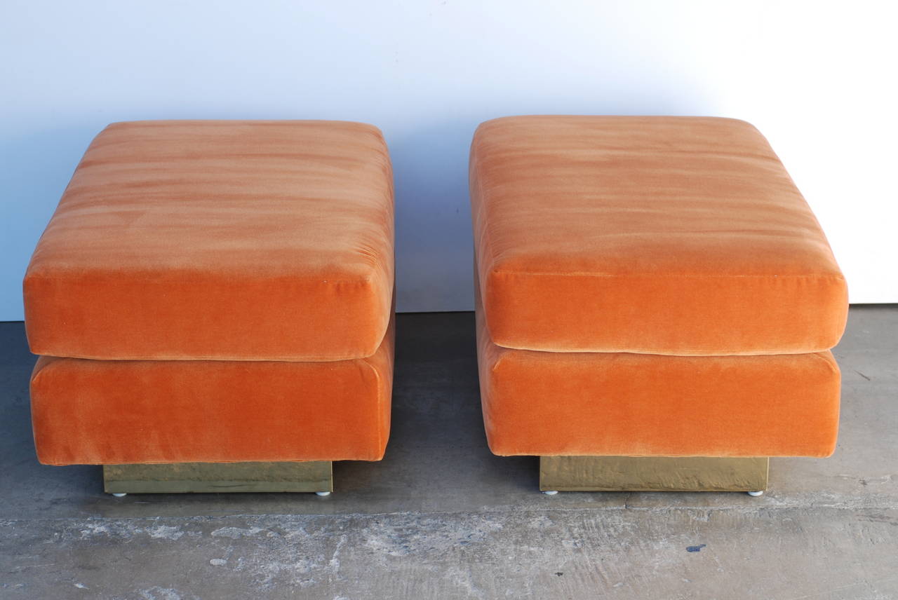 This pair of cantilevered rectangular shaped ottomans have been freshly recovered in a beautiful orange colored fine mohair. The reversible top cushion is removable.