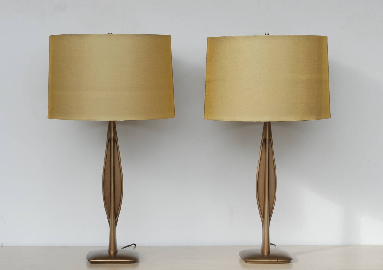 This pair of Laurel table lamps have been plated in burnished brass. The finish has depth and warmth. The base plate is 7" square and the shade is 11" high and measures 16" at the top and 17" at the bottom of the shade.
The