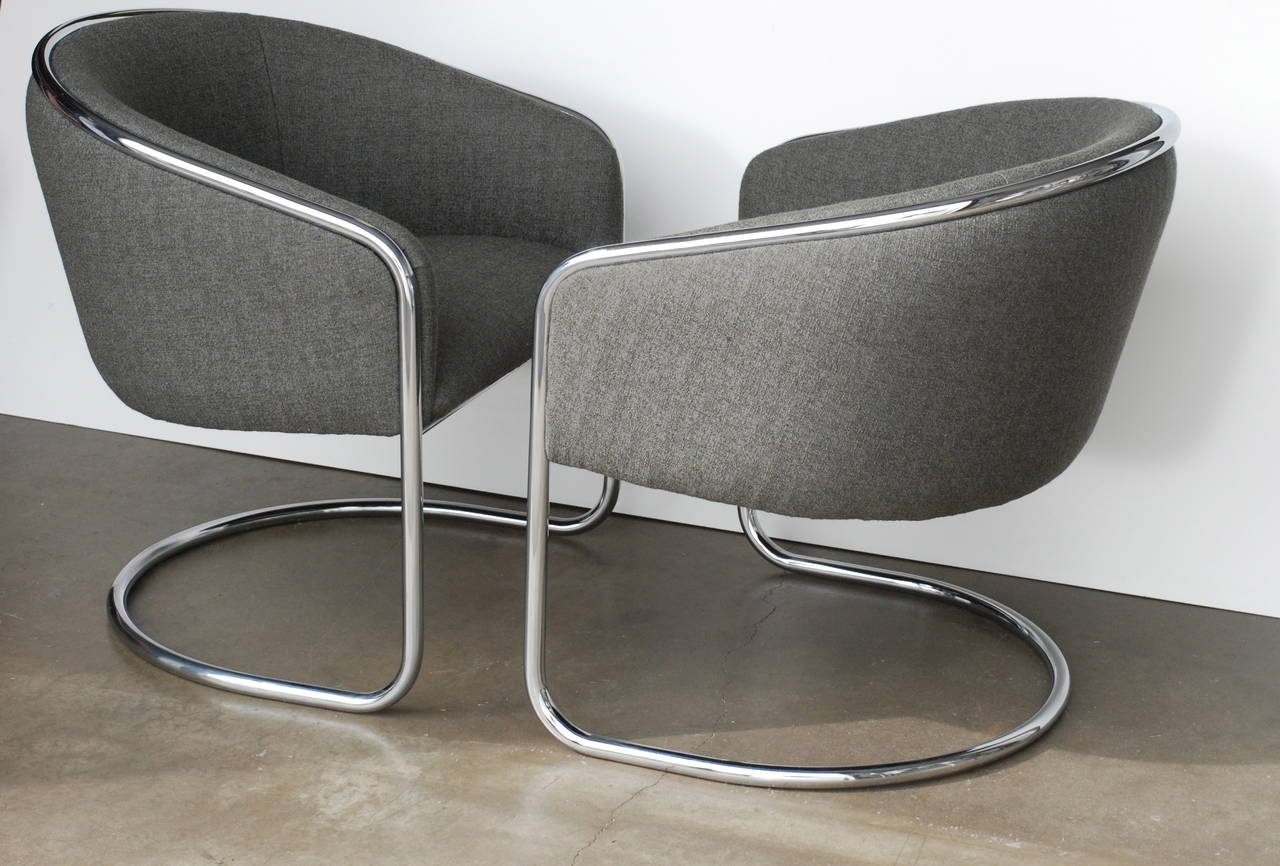 These cantilevered Thonet barrel back club chairs are very comfortable. They have been expertly reupholstered in a tight charcoal bouclé gray fabric. The continuous tubular line design is a modern classic.