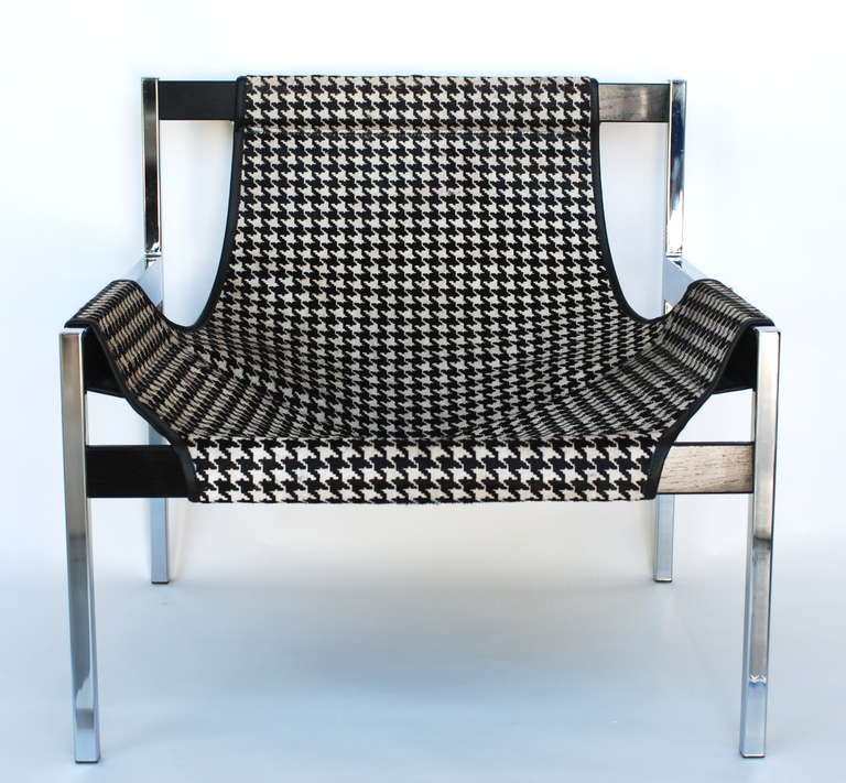 This Sling Lounge Chair 603 is made of polished chrome steel and black-stained mahogany frame.  The upholstery has been streamlined and recovered in a unique black and white printed houndstooth on hair hide.  It is designed by Byron Betker and Jerry