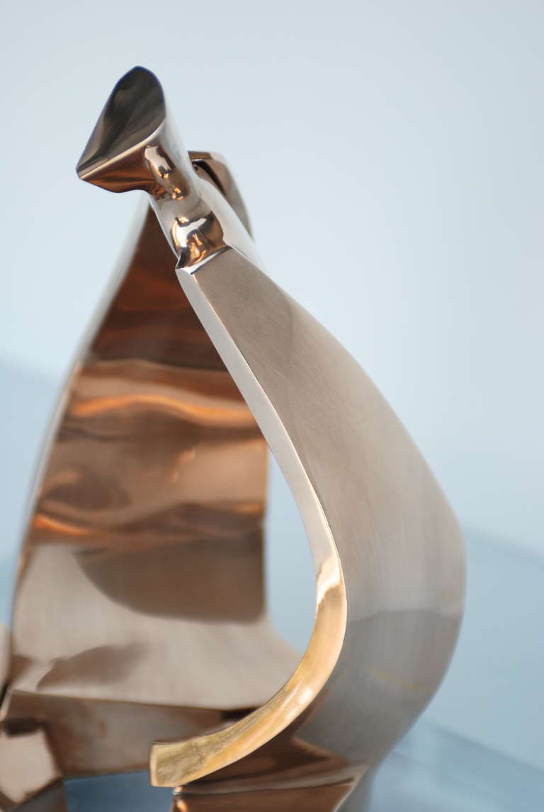 This elegant abstract bronze sculpture is signed D.Delo 19/150 S and mounted on a thick lucite base.  It retains the original sticker from Pragos.