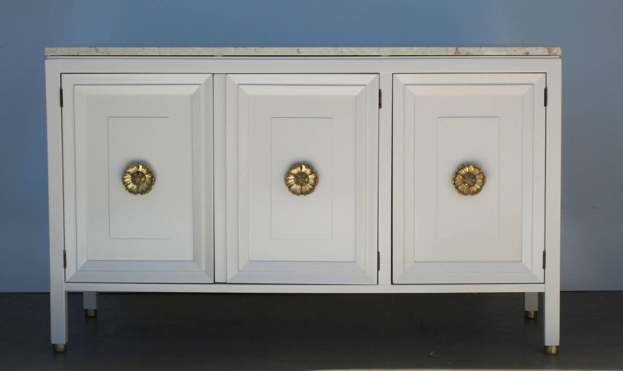 The original brass finished hardware on this cabinet is exquisite. The Italian marble top is in good vintage condition. There are brass sabots on the feet. The two left side doors open to reveal two drawers; the top one has a divider.
It has been