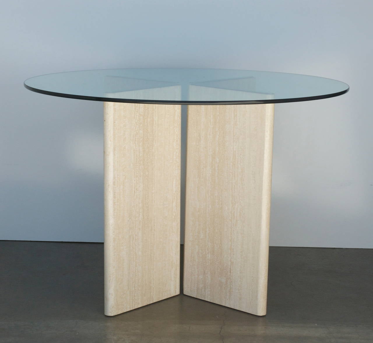 These versatile travertine and brass bases can be topped with the glass of your choice. It can be a console, a dining table, an entry table, or a writing table.
The travertine has been professionally cleaned and polished. The stone bases are