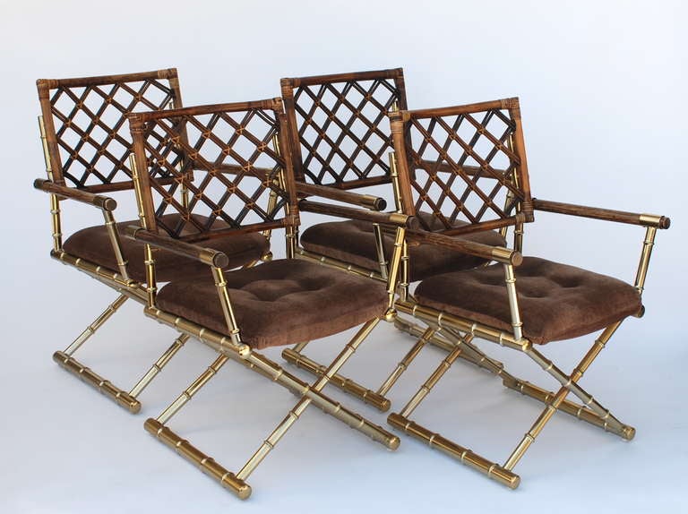 This set of chairs are a stylish interpretation of directors chairs. 
The brass plating and rattan are in excellent condition for their age.
The brown seat cushion has a herringbone pattern on the original fabric.