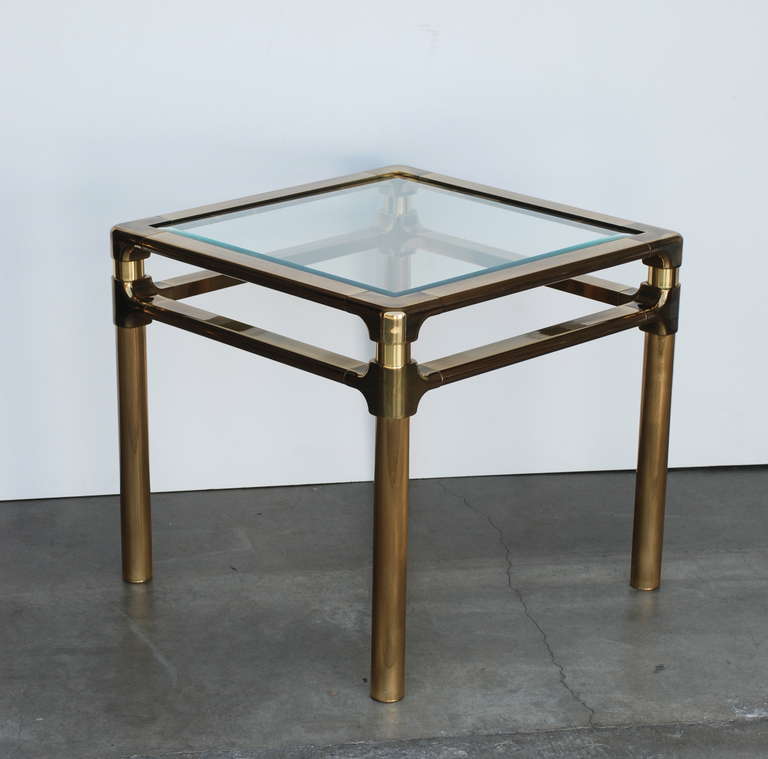 This is a nice and heavy high quality brass 1970s era side or end table manufactured by mastercraft.  It has a beveled glass top.  We have a rectangular version of this same table listed in a separate posting.