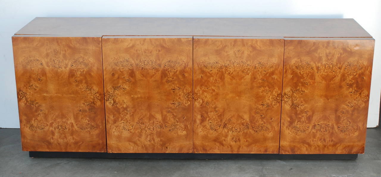 Excellent for entertainment storage needs, this Milo Baughman attributed credenza has four doors which open to reveal a dividing shelf on each side.
The left side has two top drawers.
The cabinet has been restored.