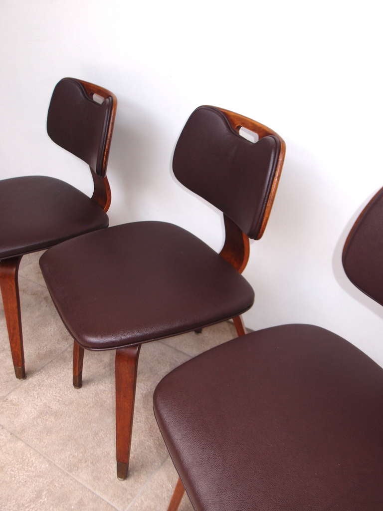 These 1950s era Thonet chairs have been reupholstered in Edelman Scotchgrain Leather in a color called Pitch Brown. (The original vinyl was beyond repair) 
The wood has been reconditioned and purposefully left aged to maintain the chairs vintage
