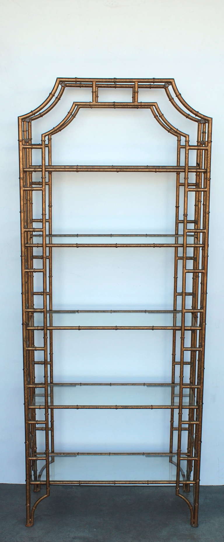 A nice pair of gilt metal faux bamboo etageres.  The metal gilding has a nice bronze shade to it.  Each etagere has five shelves. There are screw holes on the back section to secure to the wall if so desired.