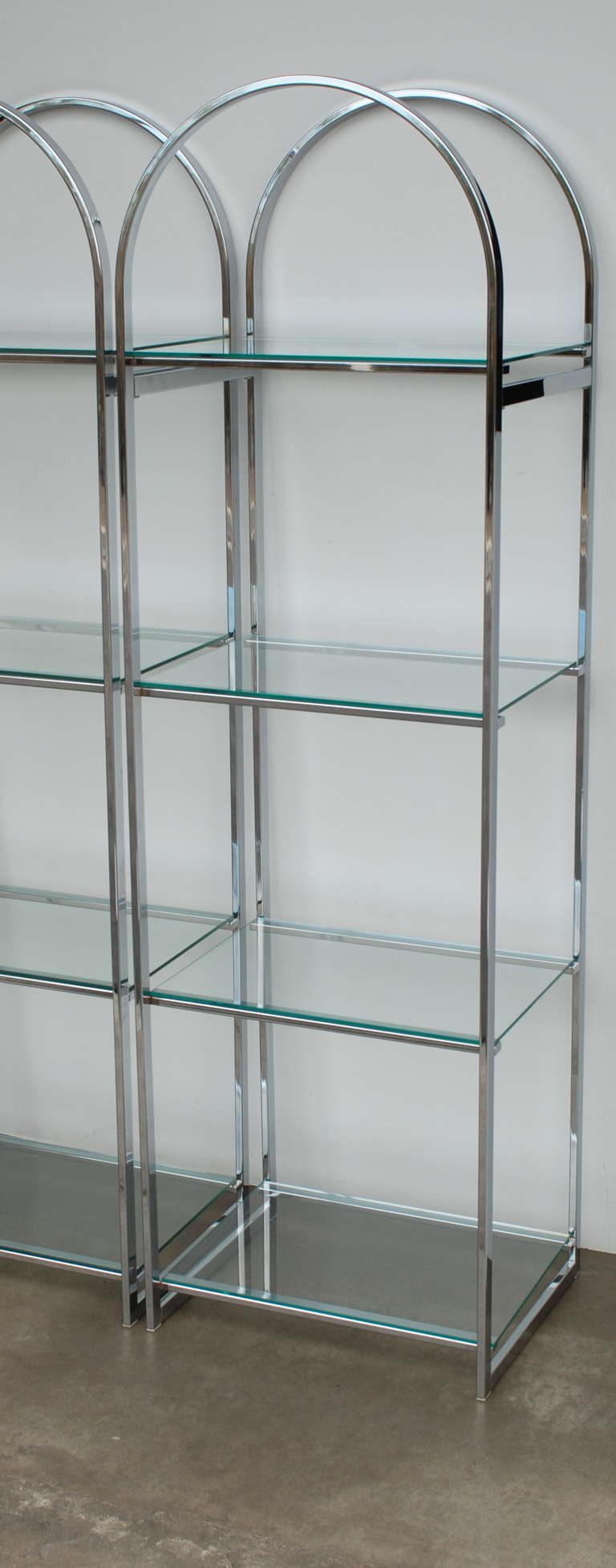 There are four shelves on each of these 1970s era etageres.  They are made with chrome finished flat bar construction and are in excellent vintage condition.