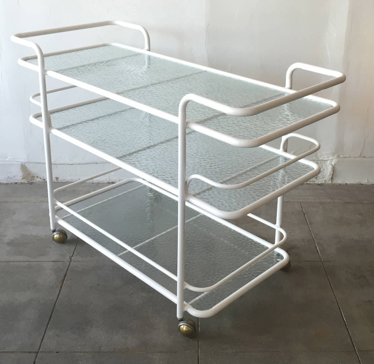 Powder coated white over the original tubular Alcoa Aluminum this bar cart was designed in 1956 by Tadao E. Inouyer as part of the 'Kantan' series for Brown Jordan. The cart is in excellent vintage condition.