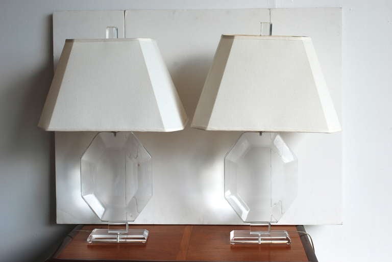 A beautiful pair of acrylic lamps in the style of Karl Springer & Les Prismatiqutes.
They are unsigned.
The lucite is in great condition for their age.  They have nice thick lucite finials and the cord is  hidden along the edge of the lamp as