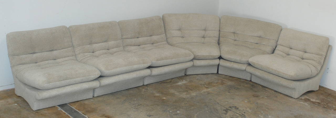 A six-piece sectional.  It has been recovered in a light natural oatmeal colored bouclé fabric and the foam has been replaced so the couch is fresh and ready to go. The sectional consists of four straight pieces which measure 31