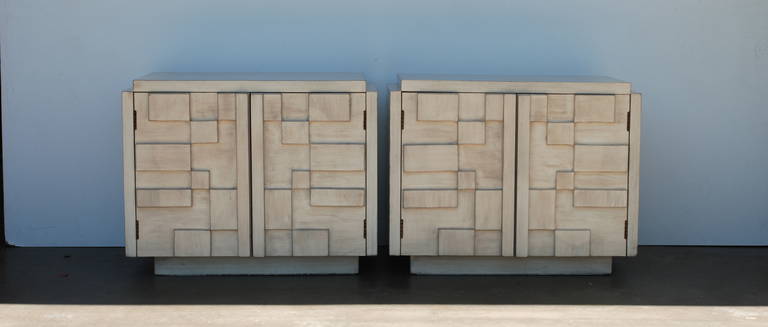 These cubist effect brutalist style nightstands are manufactured by Lane. They have been refinished in a driftwood finish that has a lightness and a depth which enhances the dimensional effect of the doors.  The doors open to reveal a shelf inside. 