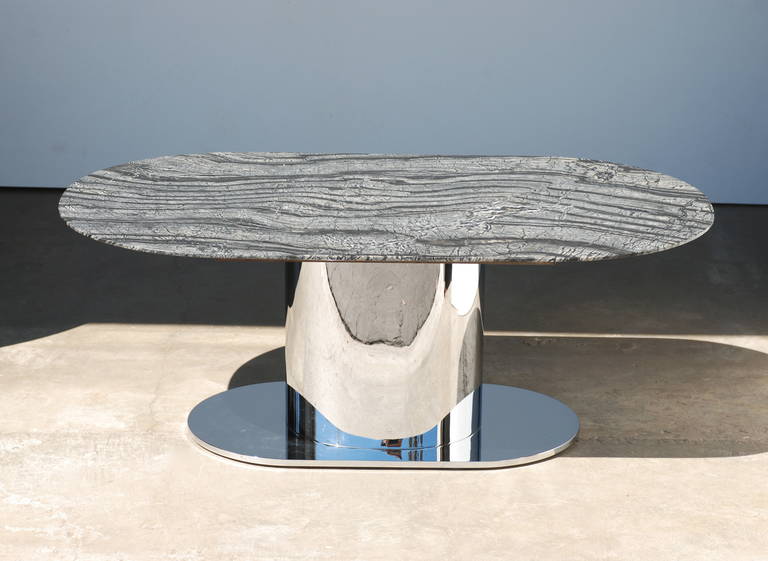 This 1970s era heavy polished stainless racetrack shaped coffee table base has a newly fabricated Kenya Black Marble with a knife edge that has a beautiful veining. The base is of the quality and style of Leon Rosen for Pace  and Brueton.