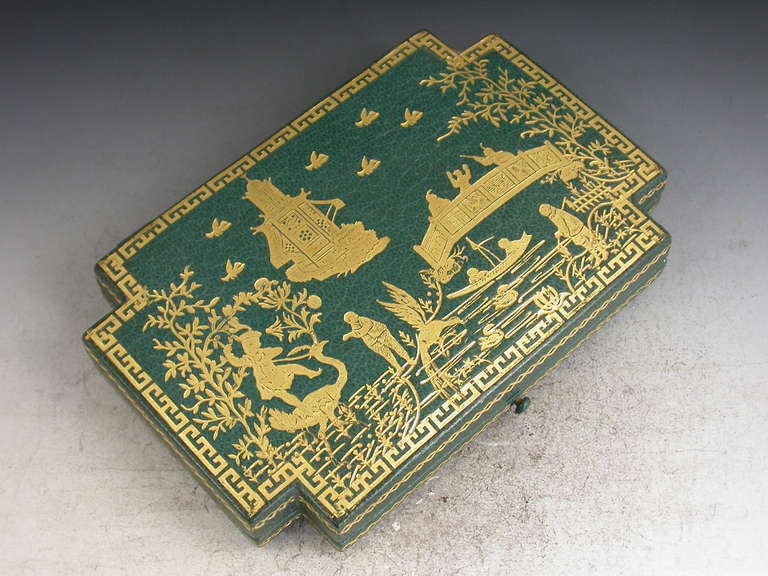 A very fine and rare sterling silver gilt Sewing Etui, complete with original rectangular dark green leather bound case with canted corners, the lid and sides decorated in gold with Chinoiserie scenes. The set consists of needle case, bodkin, needle