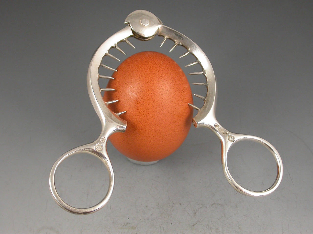 A good heavy quality pair of George V silver Egg Toppers with ring handles. 

By William Hutton & Sons Ltd, Sheffield, 1916