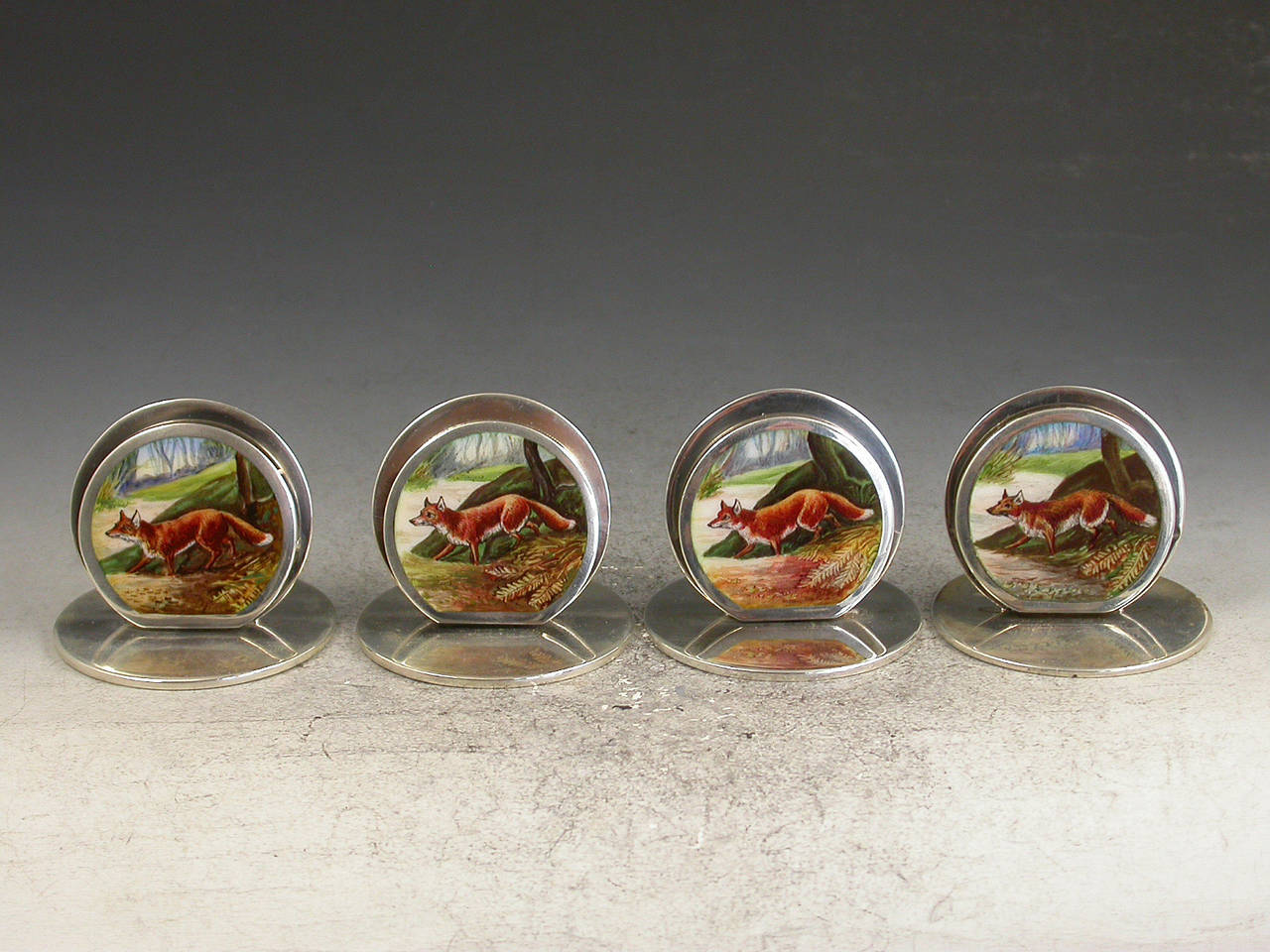 Cased Set of Four Edwardian Silver and Enamel 'Fox' Menu Holders
