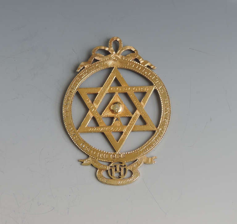 An extremely rare George III silver gilt Masonic Royal Arch Chapter Jewel, pierced with Masonic emblems and numbered 985.

By Thomas Harper, London, 1813. 

Literature: The year 1813 is significant because it was there year that the breach was