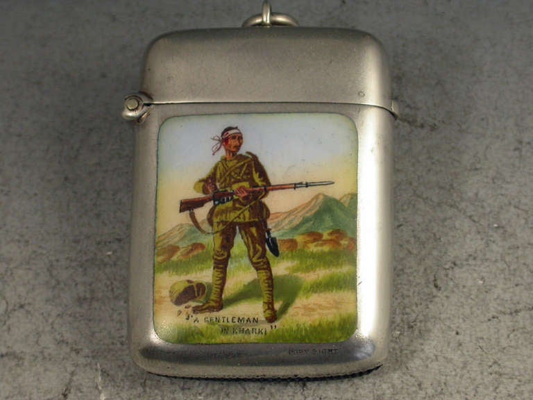 A good Victorian silver and enamel Vesta Case of rounded rectangular form with hinged flip top lid and attached suspension ring, the front with an enameled panel depicting 