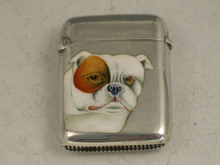 A fine quality late Victorian silver and enamel Vesta Case of rounded rectangular form with hinged flip top lid, the face enamelled with a portrait of a British Bulldog. 

By John Rose, Birmingham, 1900. 