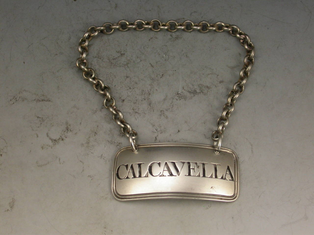 A rare George III Irish Provincial silver Wine Label of rounded rectangular form with double reeded border, incised for Calcavella. 

By Phineas Garde, Cork, assayed in Dubln circa 1815. 

Retailed by West.