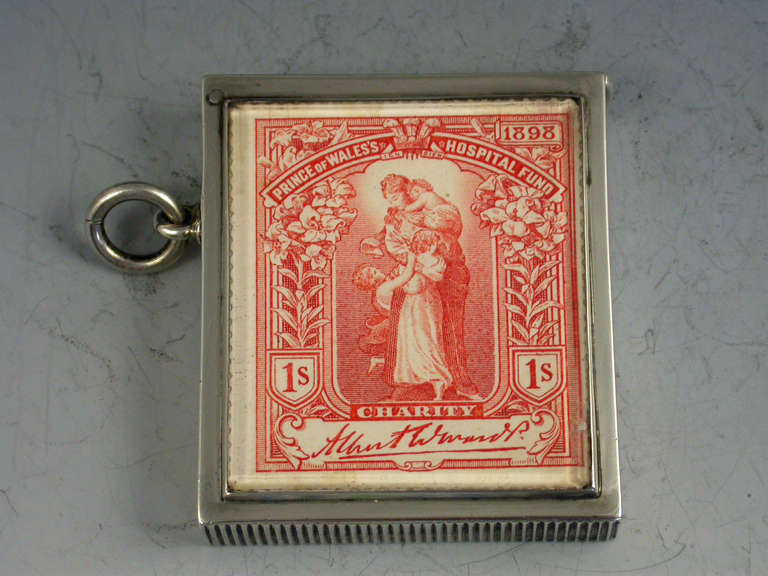 A fine and rare Victorian silver Vesta Case of large rectangular form with flat hinged lid and attached suspension ring. The face set with a glass panel covering a red one shilling charity stamp, silver gilt interior.

By Deakin & Francis,