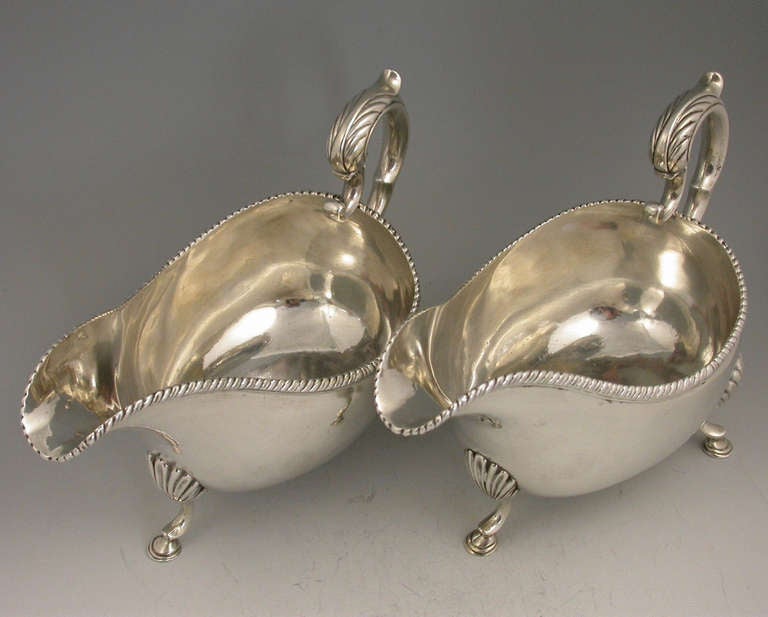 A good pair of George III large Irish sauce boats, the plain bodies with gadrooned rims and leaf capped scroll handles, standing on three hoof feet. 

By Richard Williams, Dublin, 1779.

In good condition with no damage or repair.

Measures: