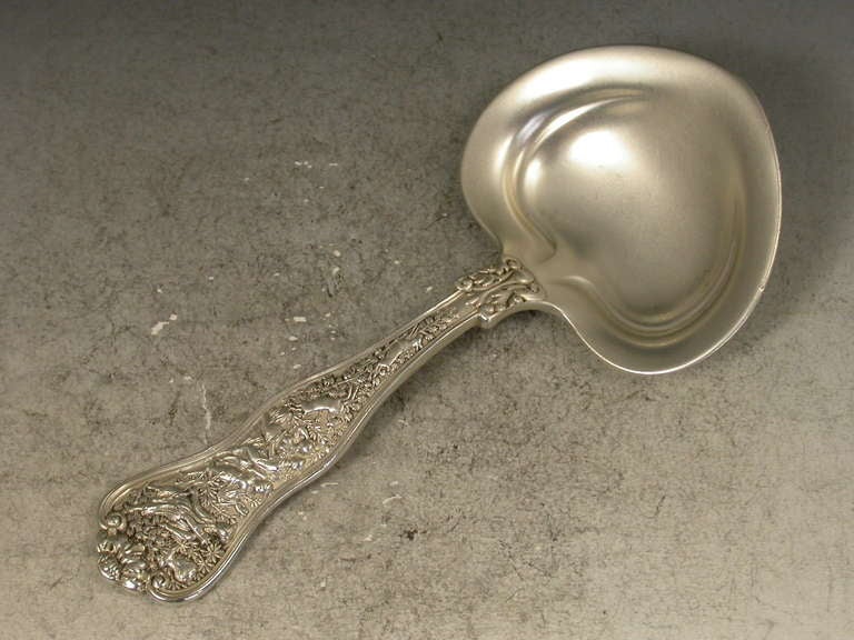 A good quality late 19th century heavy cast American sterling silver Caddy Spoon with heart shaped bowl and elaborately chased handle depicting Diana and her Nymphs. One of a series of scenes taken from Greek Mythology and collectively known as the