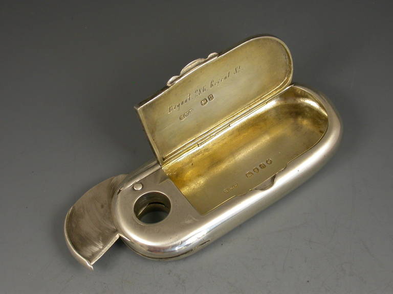 A good quality Victorian silver combined Vesta case and cigar cutter of rounded rectangular form with sharp swiveling blade at one end. The hinged cover opening to reveal a silver gilt interior.

By Henry William Dee, London, 1868. 

Retailed by