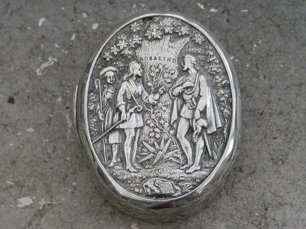 A rare Victorian silver Vinaigrette with theatrical interest, of compressed oval form with foliate scroll engraved decoration to the base and sides, the lid inset with a panel depicting a scene from Shakespeare's 