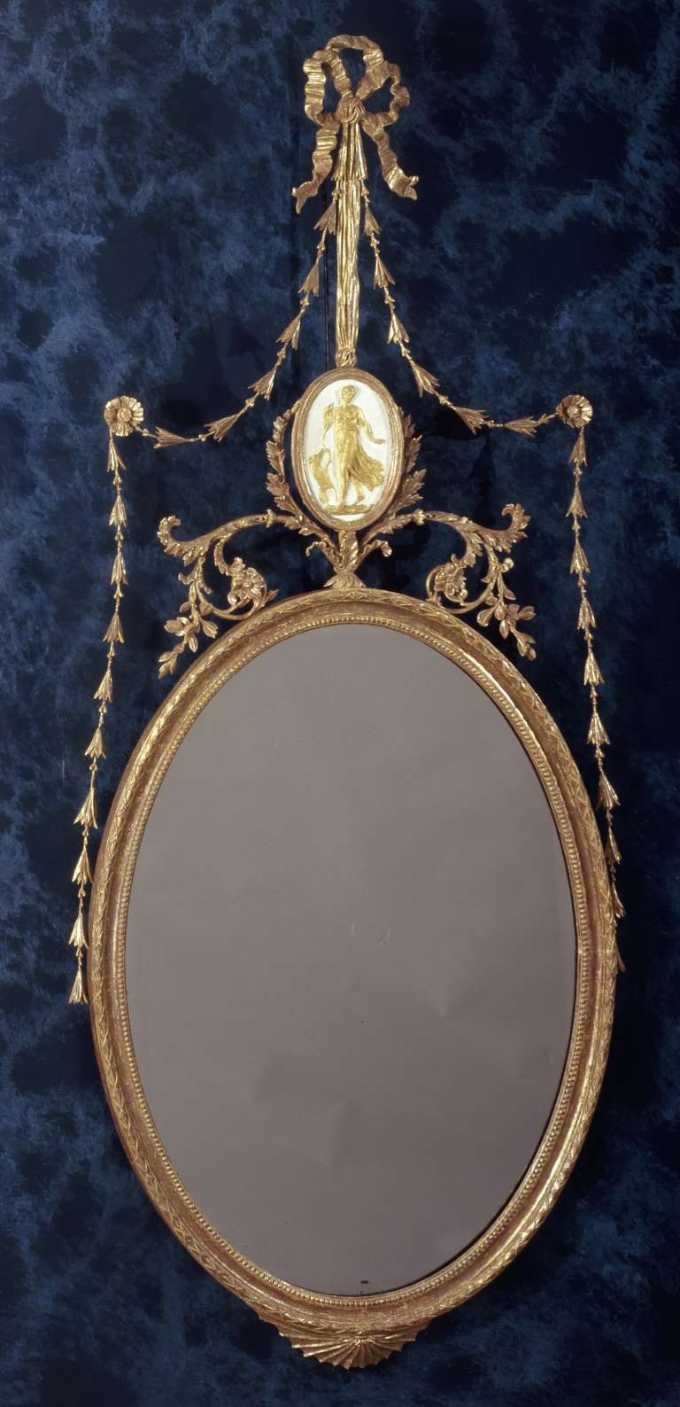 Mainly original gilding; original glass.

With a plaque in the finial depicting Diana the Huntress.

The glass is older than the frame - reuse of 