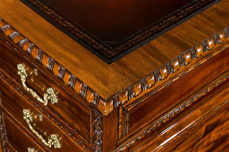 A fine quality late 19th century mahogany Chippendale style partners desk with nine drawers to the front and three drawers and cupboards to the reverse.<br />
The finely carved flowers are of the highest quality and overall the quality of the
