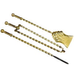 An Antique three piece set of Victorian brass fire irons