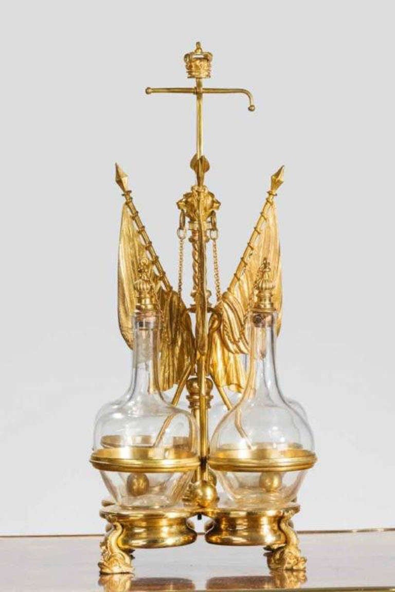 Royal Naval gilt table cruet with four coasters