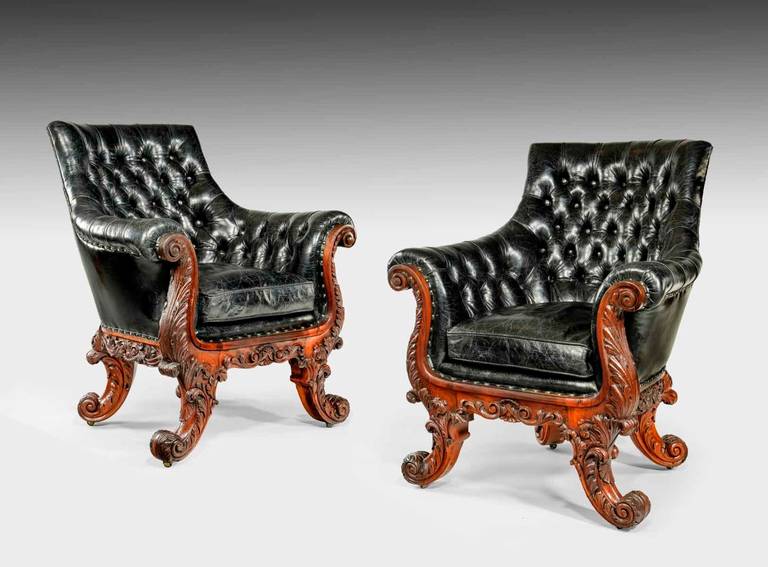 Each with a generous seat and deeply carved scrolling arms and reciprocal cabriole legs. The decoration comprises scrolls, fleshy acanthus leaves and other foliage.