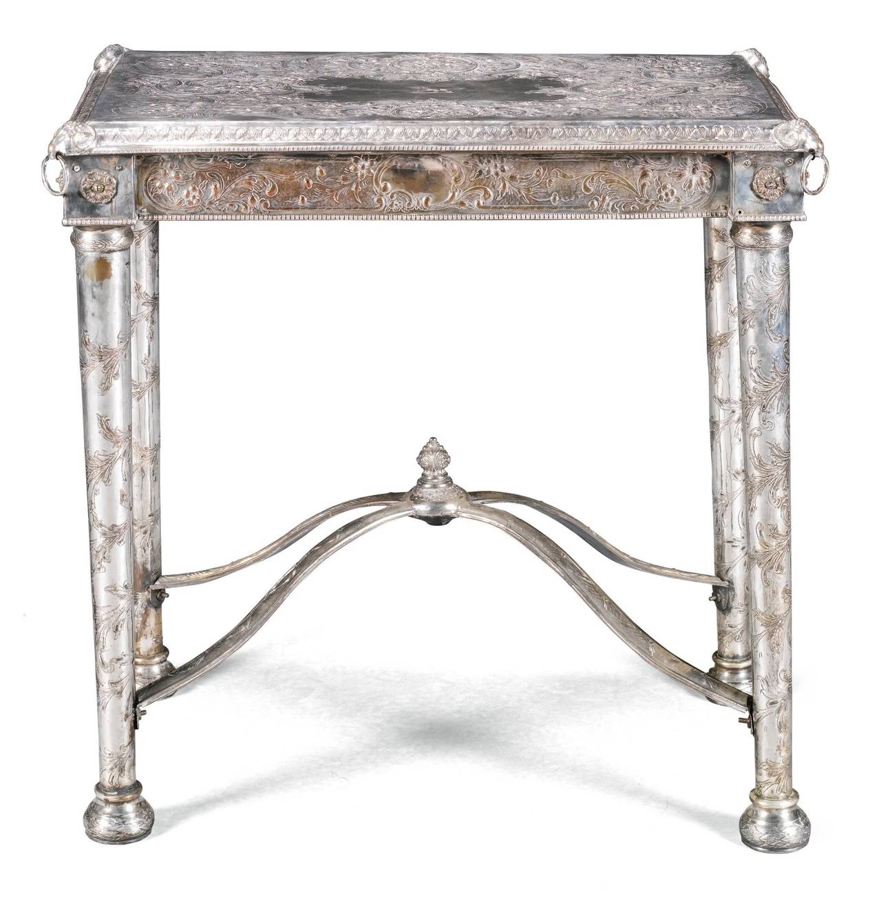 AN ANGLO-INDIAN SILVER PLATED CENTRE TABLE 19TH CENTURY in 18th century manner, the rectangular top with a leaf cast border, embossed with scrolls and flowers around a central panel engraved with a crest depicting a lion, the frieze with conforming