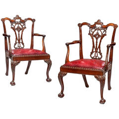 A fine pair of Victorian mahogany open armchairs in Chippendale taste