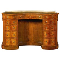 A Victorian Walnut and Feather banded kidney shaped kneehole desk