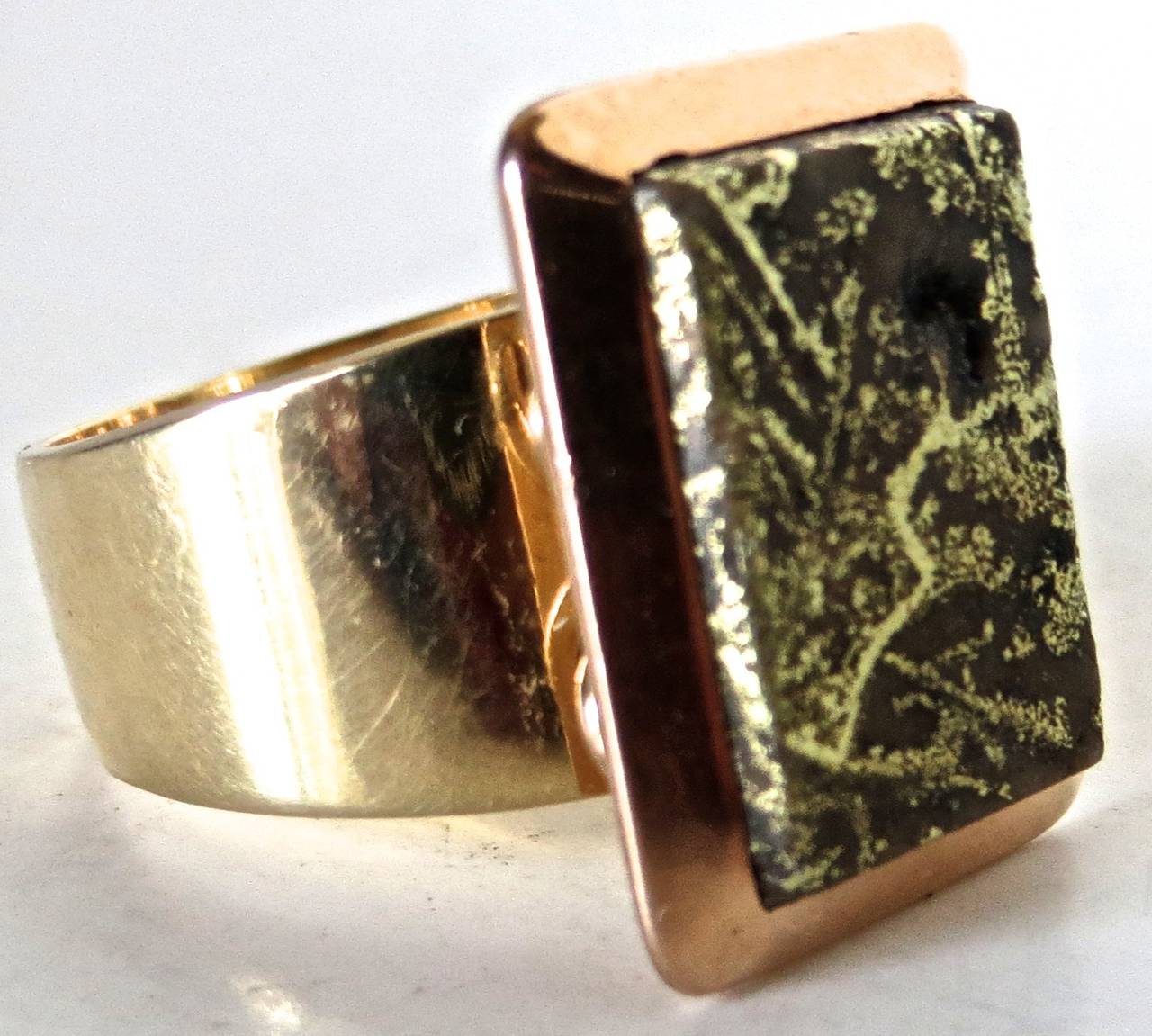 The gold quartz rectangular ring with a beveled 18-carat gold border, circa 1875, and is mounted on a later (contemporary) 14-carat gold band. It is a large size man's ring and is very attractive. The 14-carat gold band tapers from 1/2