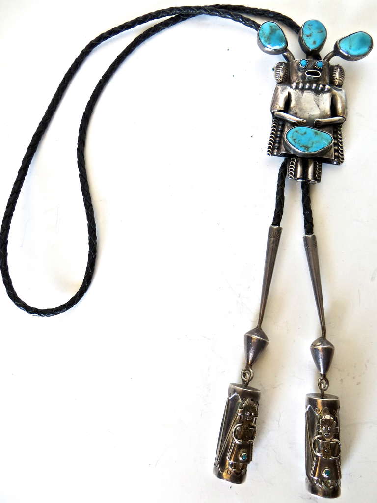 This is the Cadillac of the bolo tie as depicted by the Southwest Indians. Handcrafted by Navajo Indian Jim Yazz, circa 1960s, this silver bolo tie has four large irregular hand-cut turquoise stones measuring 3/4