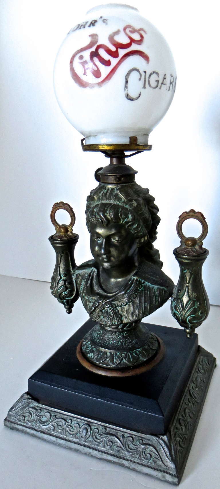 This is a top of the line cast iron gas Cigar Lighter that would have been found in American saloons in the late 19th century. It was manufactured Circa 1880. It is an elaborate and specific to detail sculptor of a beautiful woman with long hair and