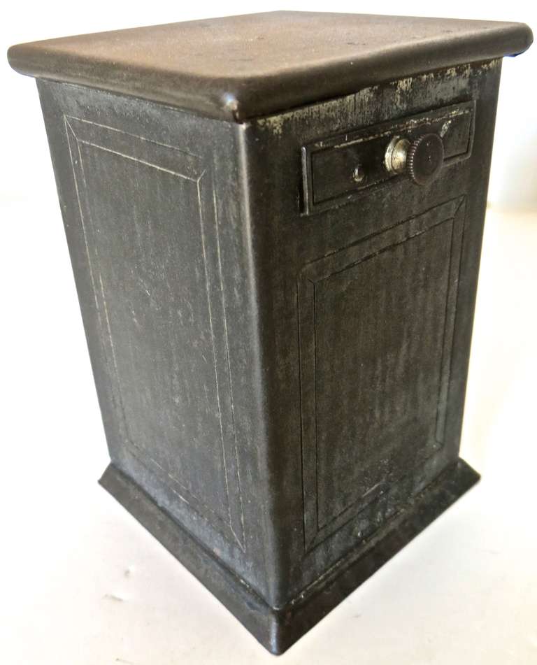 Pewter "Trick Drawer". One of a kind circa 1895, American.
 
Pull the spring held drawer out, put a penny in the tray, release and penny drops into bank having "disappeared". Action has elements of magic.
(Toothpick in image