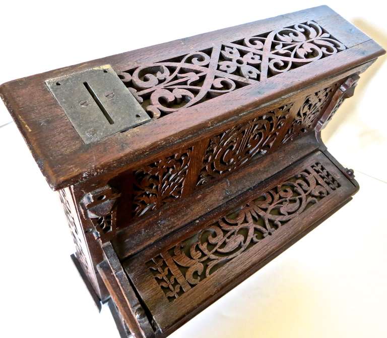 This is a wooden mechanical bank, probably of Austrian or Swiss manufacture, and is the only example of this mechanical bank that I have seen.
Intricate wooden fretwork is especially Fine, and mellow patinated hew to the mahogany makes it all the