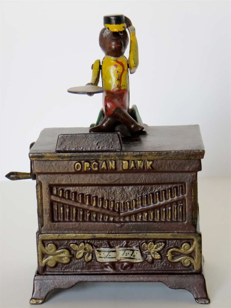Manufactured in 1881 by the Kyser & Rex Co. in Frankford, Pennsylvania, this cast iron mechanical bank is in excellent all original condition and paint. It consists of six pieces; four sides; top and bottom, held together by a turnpin. Upon placing