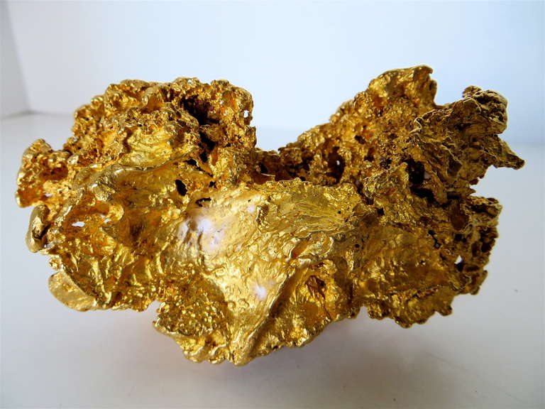 This is a rarity in that few gold nuggets have the size and beauty of this one, both in color and shape. It weighs 584.5 grams (18.8 troy ounces), and rates at 22 to 23 karats.  It has very faint indication of some quartz but is basically 95-97%
