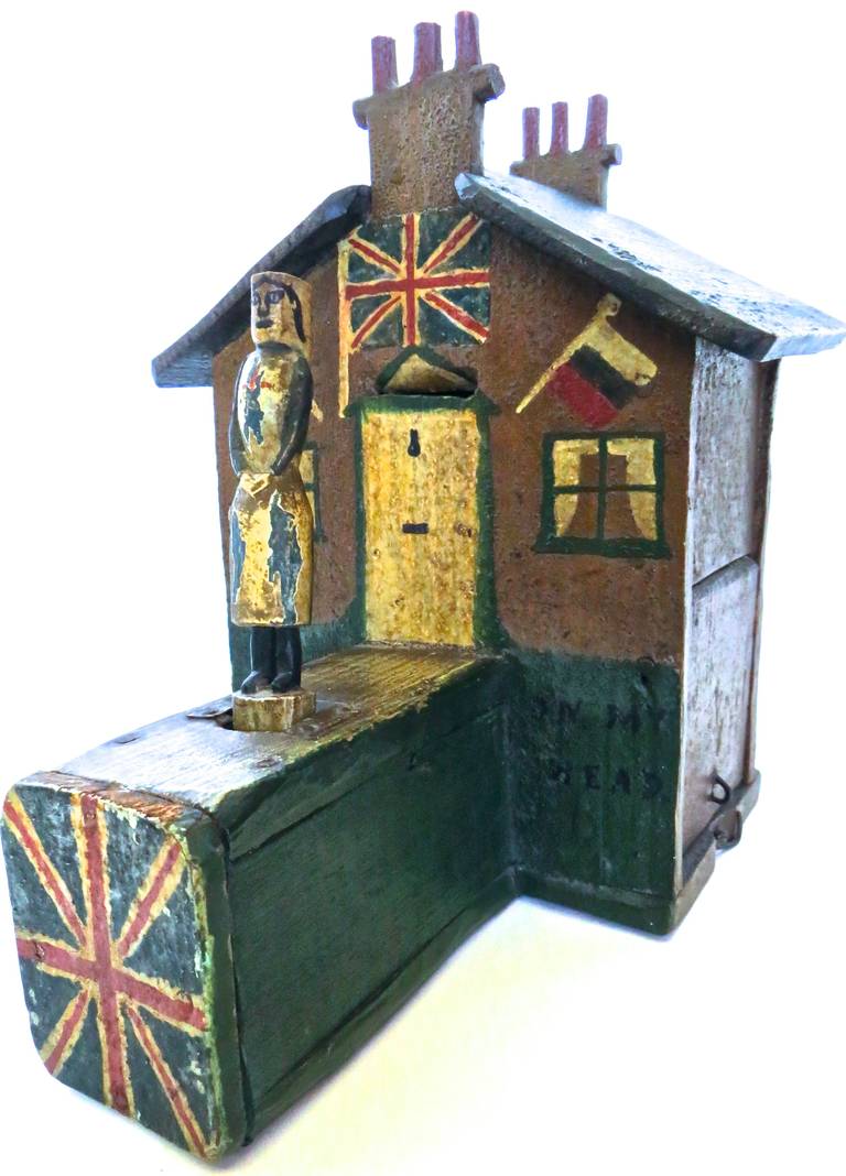 Hand-carved and hand-painted, this charming 19th century British Folk Art mechanical bank has all of the elements that constitute fine, self-taught, and creative artistic skills. The design is excellent, and operation of the bank is effective and
