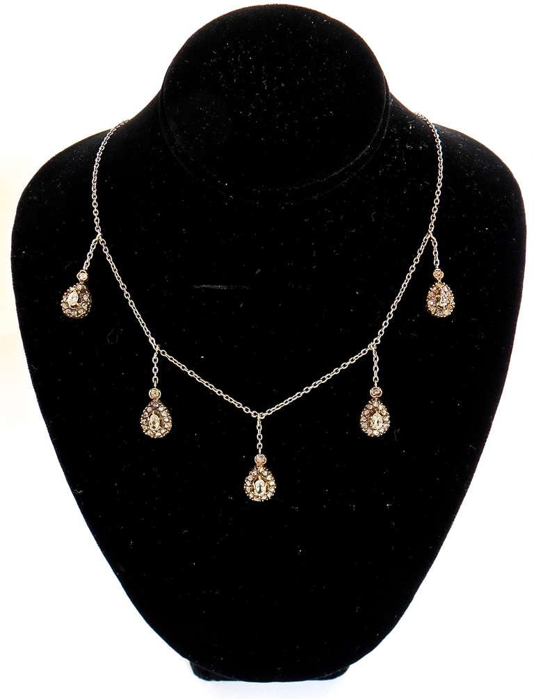14-karat white gold diamond necklace comprised of five drops on gold chain.
There are 13 diamonds on each drop.
Each drop is 7/16